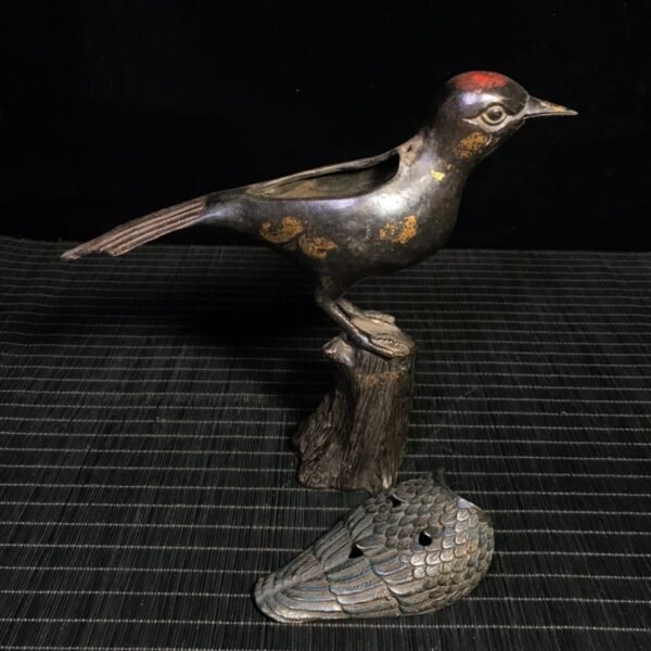 A rare gold and cinnabar colored bird stove